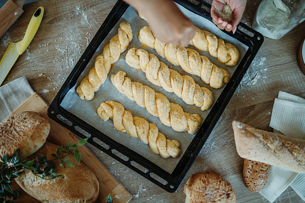istock Young caucasian woman making bread dough in her kitchen 2225632019