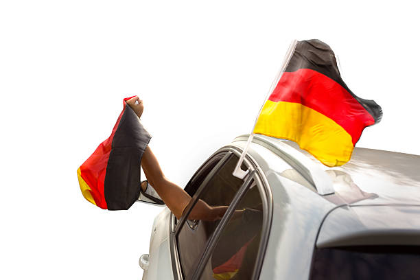istock Fan with German flag celebrating in a car isolated on white 2225632073
