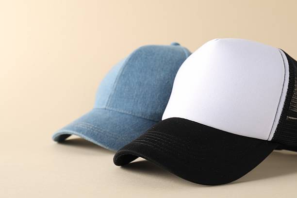 istock Stylish baseball caps on beige background, closeup. Mockup for design 2225632539