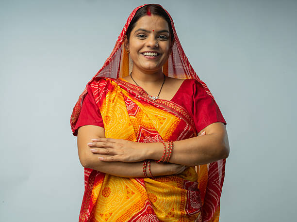 istock Woman in sari standing against white background 2225632571