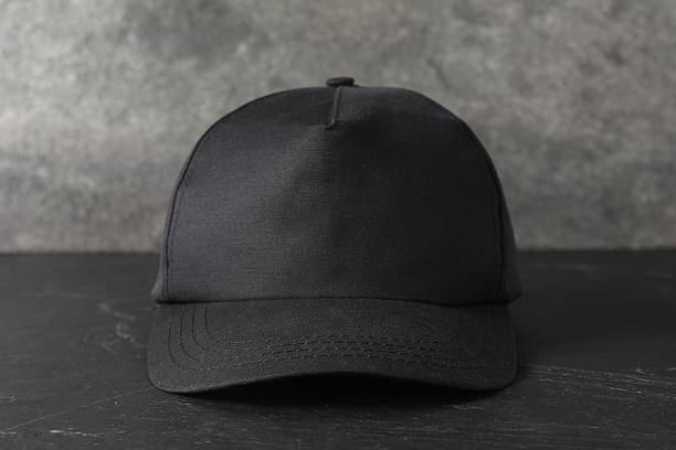 istock Stylish baseball cap on dark textured table, closeup. Mockup for design 2225632638