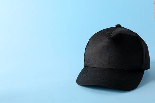istock Stylish black baseball cap on light blue background. Mockup for design 2225632686