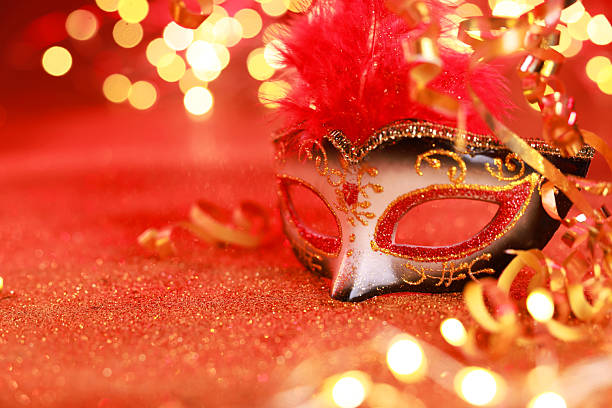 istock Beautiful carnival mask on shiny red background, closeup. Bokeh effect 2225633069