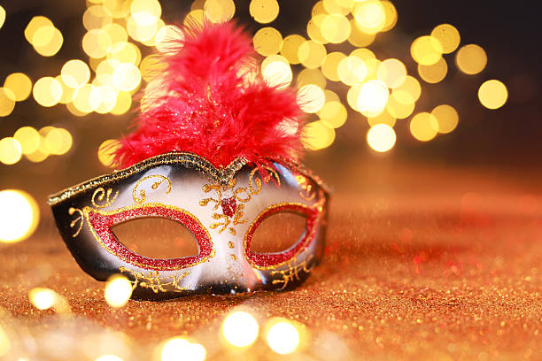 istock Beautiful carnival mask on shiny color background, closeup. Bokeh effect 2225633077