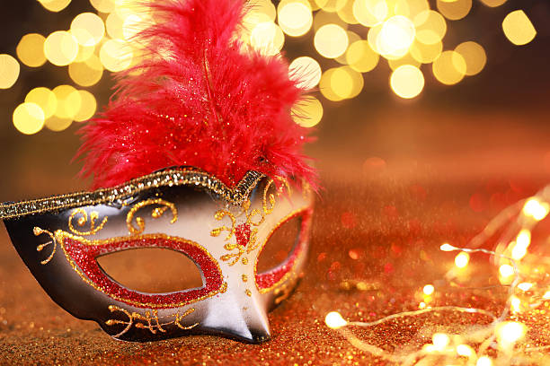 istock Beautiful carnival mask on shiny color background, closeup. Bokeh effect 2225633103