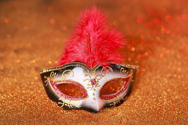 Beautiful carnival mask on shiny color background, closeup