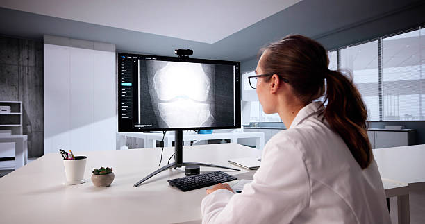 istock Young Female Doctor Screens Knee Bone X-ray 2225634490