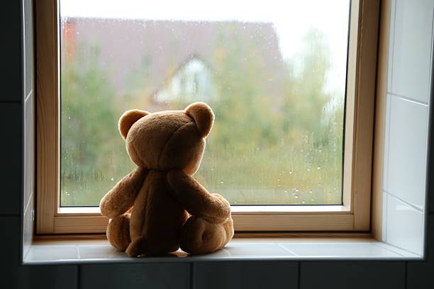 Close-up image of a teddy bear's face adorned with round glasses, showcasing its soft texture and endearing expression, captured with a clear background for emphasis.
