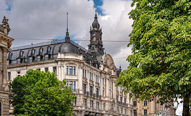istock Baroque Architecture In Munich: Ornate Historic Building With Sculpted Facade, Arched Windows, Decorative Columns, And Stone Details Under Blue Sky With Clouds In Vibrant Urban Cityscape 2225635852