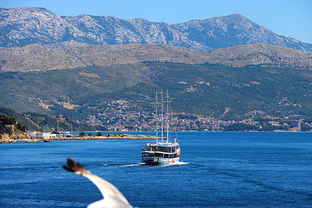 Sailing boat on the Adriatic sea. View of Podstrana, small coastal town in Croatia.