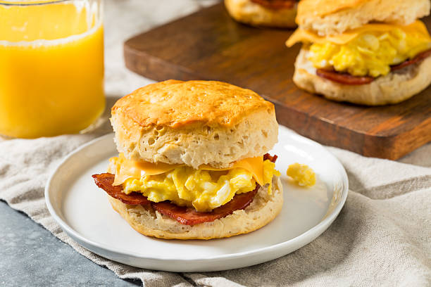 Greasy Bacon Egg and Cheese Buttermilk Biscuit Sandwich for Breakfast