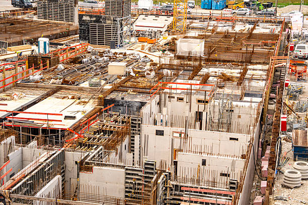 istock Construction Site In Freiham Munich Bavaria: Large Building Foundation With Concrete Structures, Yellow Cranes, Steel Framework, And Urban Housing In Background Under Partly Cloudy Sky 2225648423