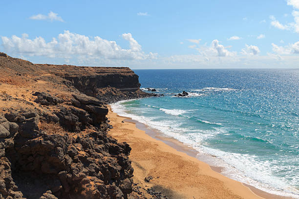 istock Beautiful sandy beach with rocky cliffs and waves 2225648889