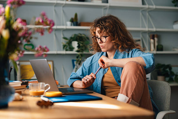 istock Woman Working at Home in a Comfortable Living Room Office Setting 2225649042