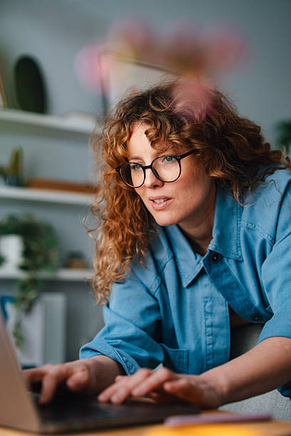 istock Focused Woman Working on a Laptop in a Cozy Home Office Setting 2225649063