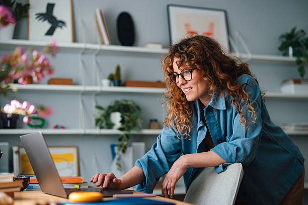 istock Woman Working on Laptop in a Stylish Home Office Environment 2225649070