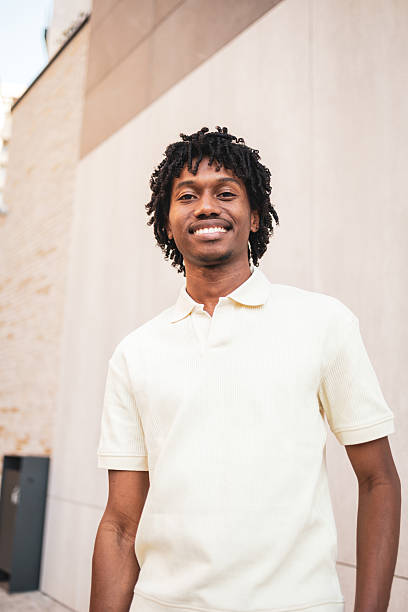 istock Young man smiling and looking at camera in the city 2225649874