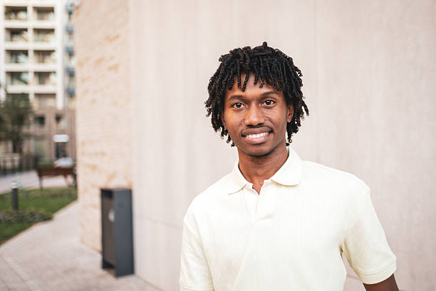 istock Young man smiling and posing in urban setting 2225649879