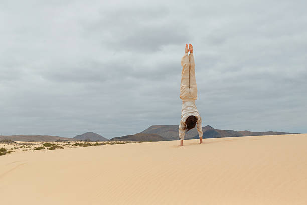 istock Person performs handstand in desert landscape 2225650094