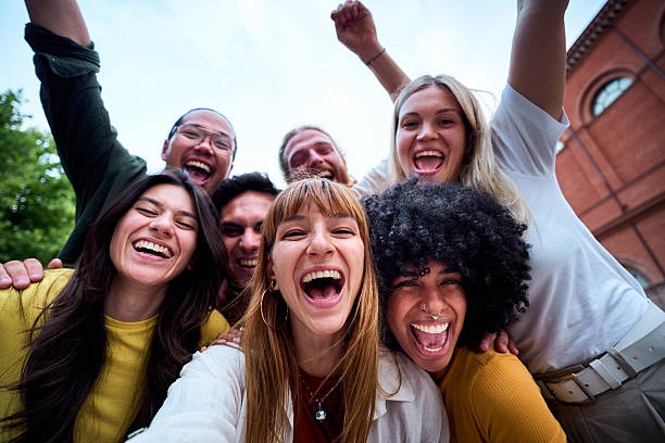 istock Happy young students celebrating success with arms raised and screaming 2225651388