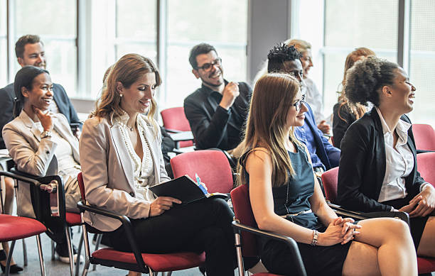 istock Diverse Business Executives Engaged with Conference Presentation in Modern Setting 2225652618