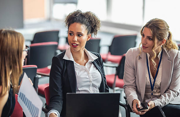 istock Businesswomen Engaging in Professional Discussion at Conference 2225652675