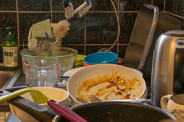 istock Dirty crockery and pans on a kitchen worktop. 2225654384