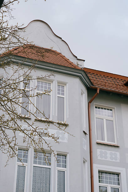 istock Historical architecture. modenrn. large building with a red roof and white trim. 2225660584