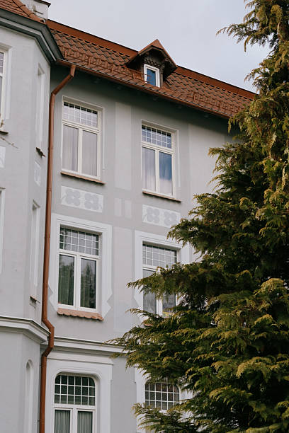 istock Historical architecture. modenrn. large building with a red roof and white trim. 2225660637