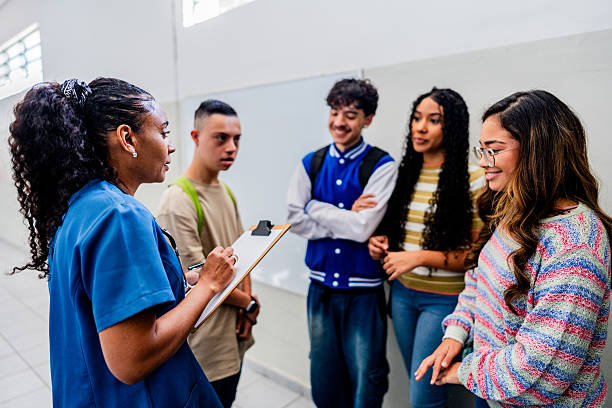 istock Doctor talking to and checking students before vaccination at school 2225662883