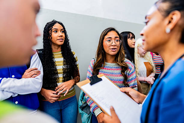 istock Doctor talking to and checking students before vaccination at school 2225663526