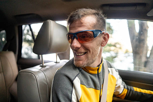 Mid adult man driving on a forest road