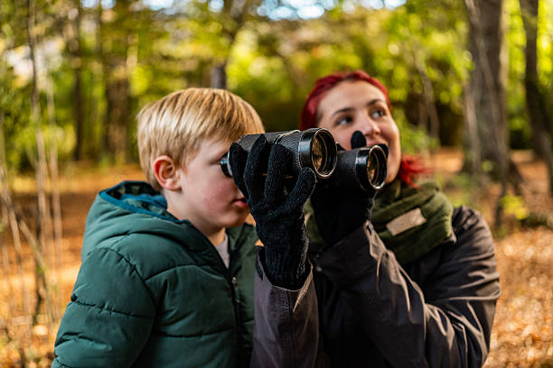 istock Mother and son using binoculars, observing the forest in Patagonia, Argentina 2225666093