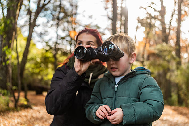 istock Mother and son using binoculars, observing the forest in Patagonia, Argentina 2225666095