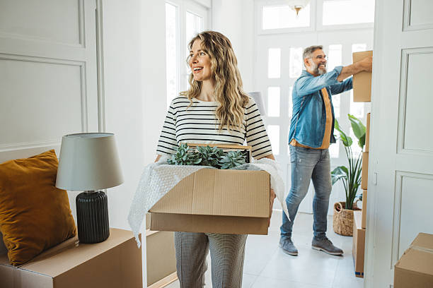 istock Mature Couple with Moving Boxes in New Home 2225668712
