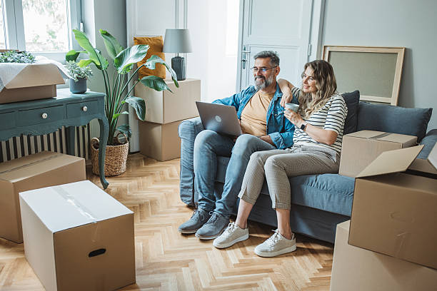 istock Mature Couple with Moving Boxes in New Home 2225668737
