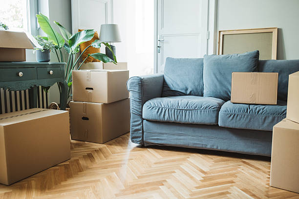 istock Moving day concept, cardboard boxes in modern house 2225669262
