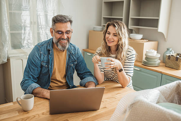 istock Mature Couple with Moving Boxes in New Home 2225669298