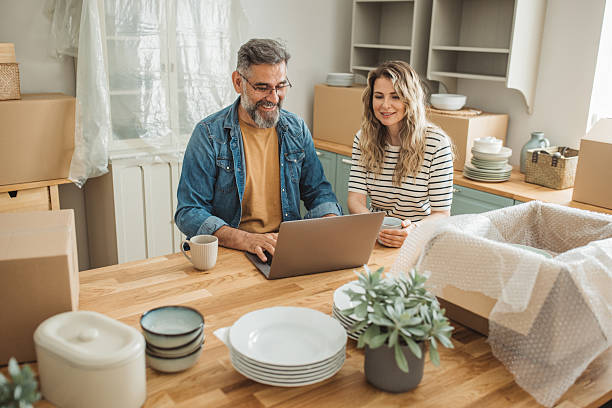 istock Mature Couple with Moving Boxes in New Home 2225669304