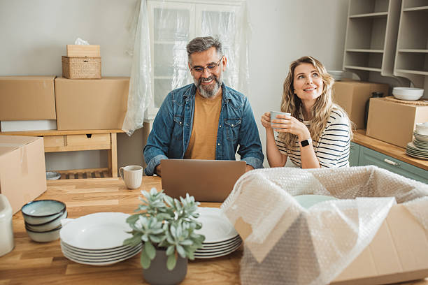 istock Mature Couple with Moving Boxes in New Home 2225669307