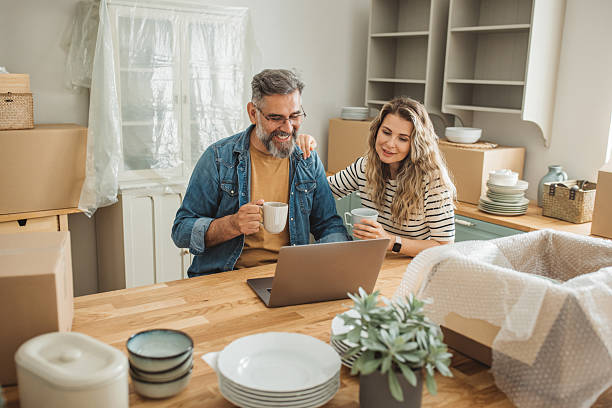 istock Mature Couple with Moving Boxes in New Home 2225669308