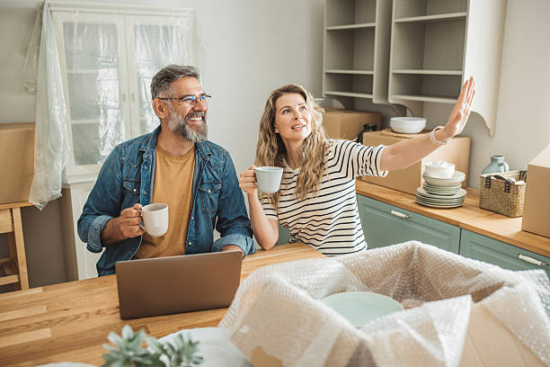 istock Mature Couple with Moving Boxes in New Home 2225669309