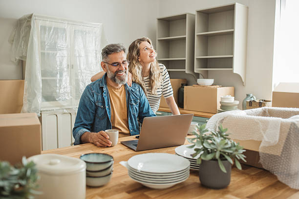 istock Mature Couple with Moving Boxes in New Home 2225669312