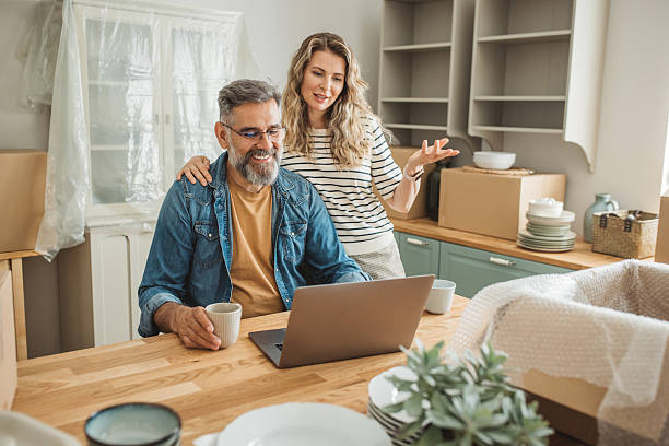 istock Mature Couple with Moving Boxes in New Home 2225669315