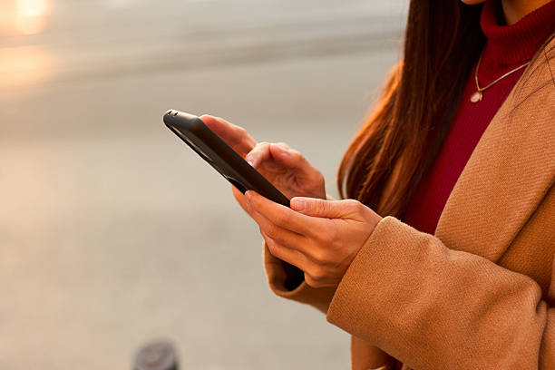 istock Woman Using Mobile Phone Outdoors 2225675849