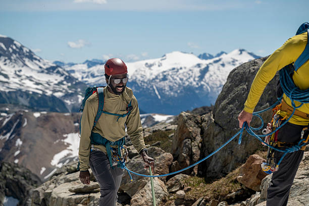 istock Climbing guide leads client on rope along mountain ridge 2225676166