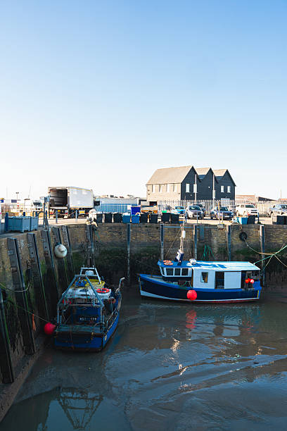 istock Fishing boat moored at low tide in whitstable harbour, kent, england 2225677716