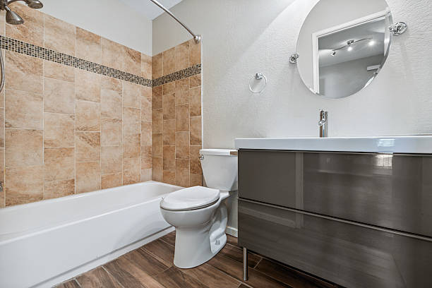 istock This is a bathroom that includes a toilet, sink, bathtub, and a mirror 2225683519