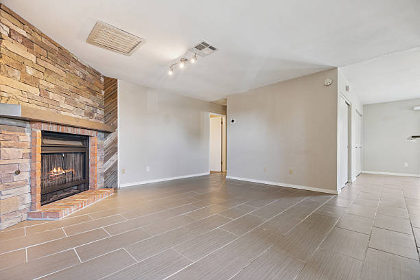 istock An empty living room featuring a fireplace complemented by a brick wall 2225683949