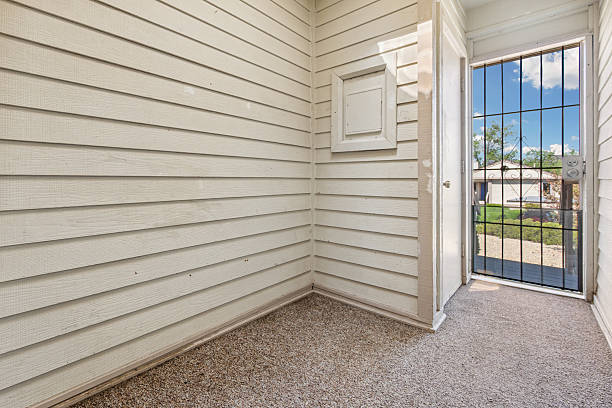 istock An empty room within a house that features a door and a window 2225689570